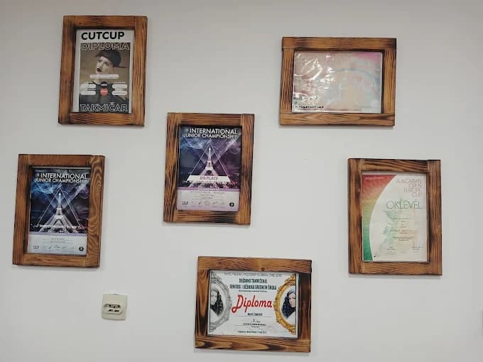 Professional barbering certificates and diplomas displayed at FENIX